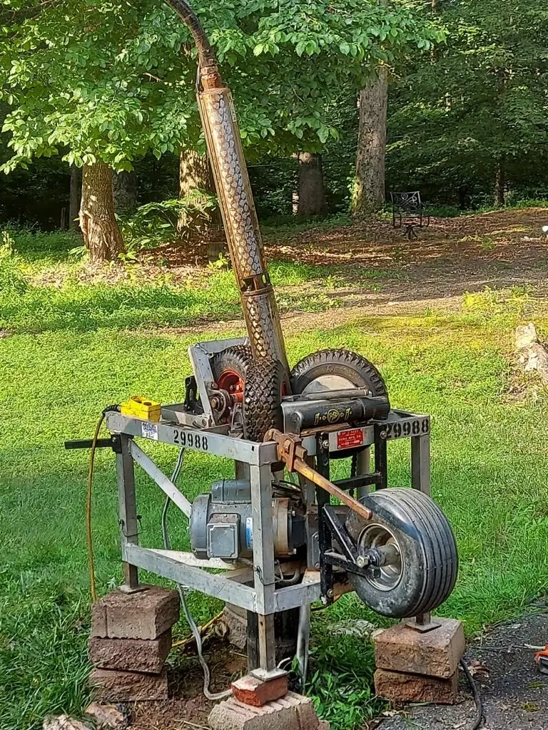 Portable pump hoist set over a well on a Maryland lawn to pull a failed well pump